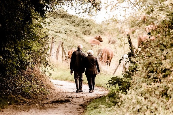 Couple walking down country lane, staying mobile to stay independent