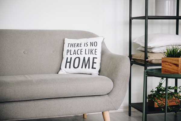 Picture of couch with pillow there's no place like home